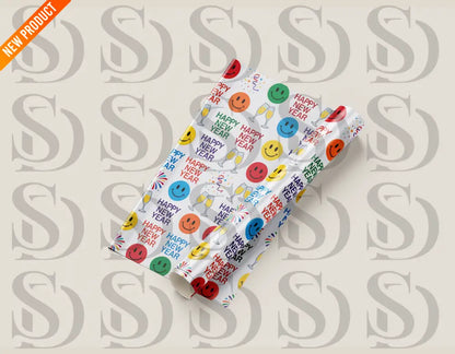 A vibrant wrapping paper featuring colorful smiley faces, fireworks, gift boxes, and the text "Happy New Year" in bright colors. Perfect for festive occasions.