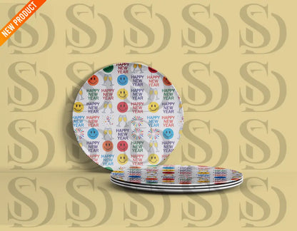 Plates featuring a cheerful New Year design with colorful smiley faces, fireworks, gift boxes, and “Happy New Year” in various colors.