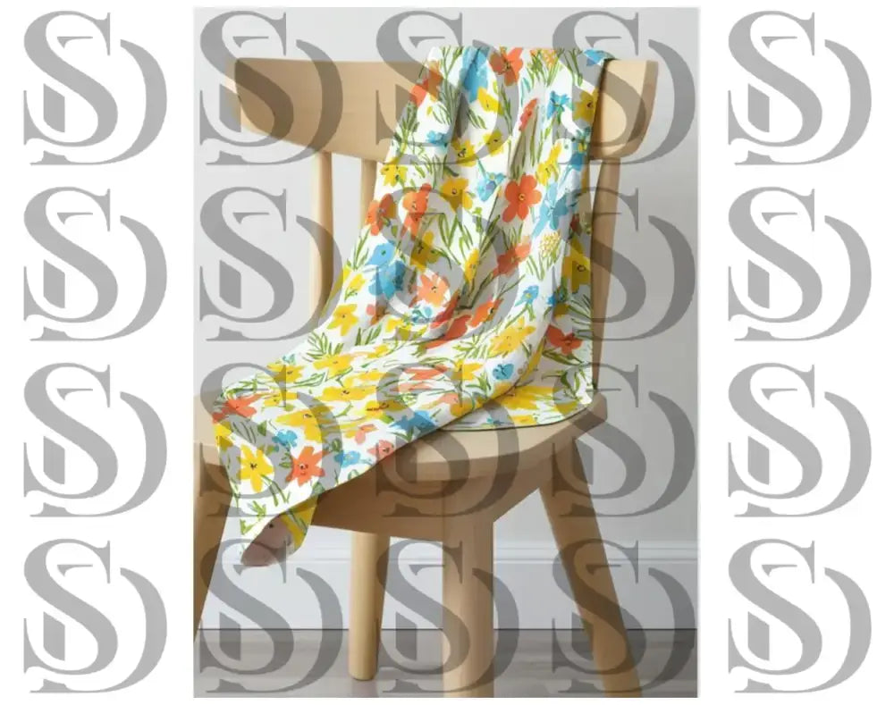 Draped fabric featuring colorful floral seamless pattern on chair