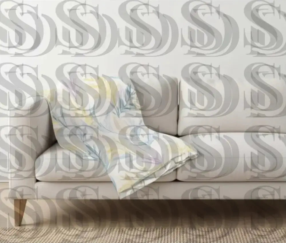 Sofa throw blanket showcasing a pastel botanical leaf fabric pattern